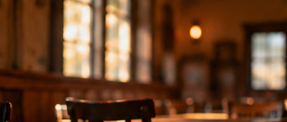 Illustrative photo of a warm wooden dining room; not the actual restaurant